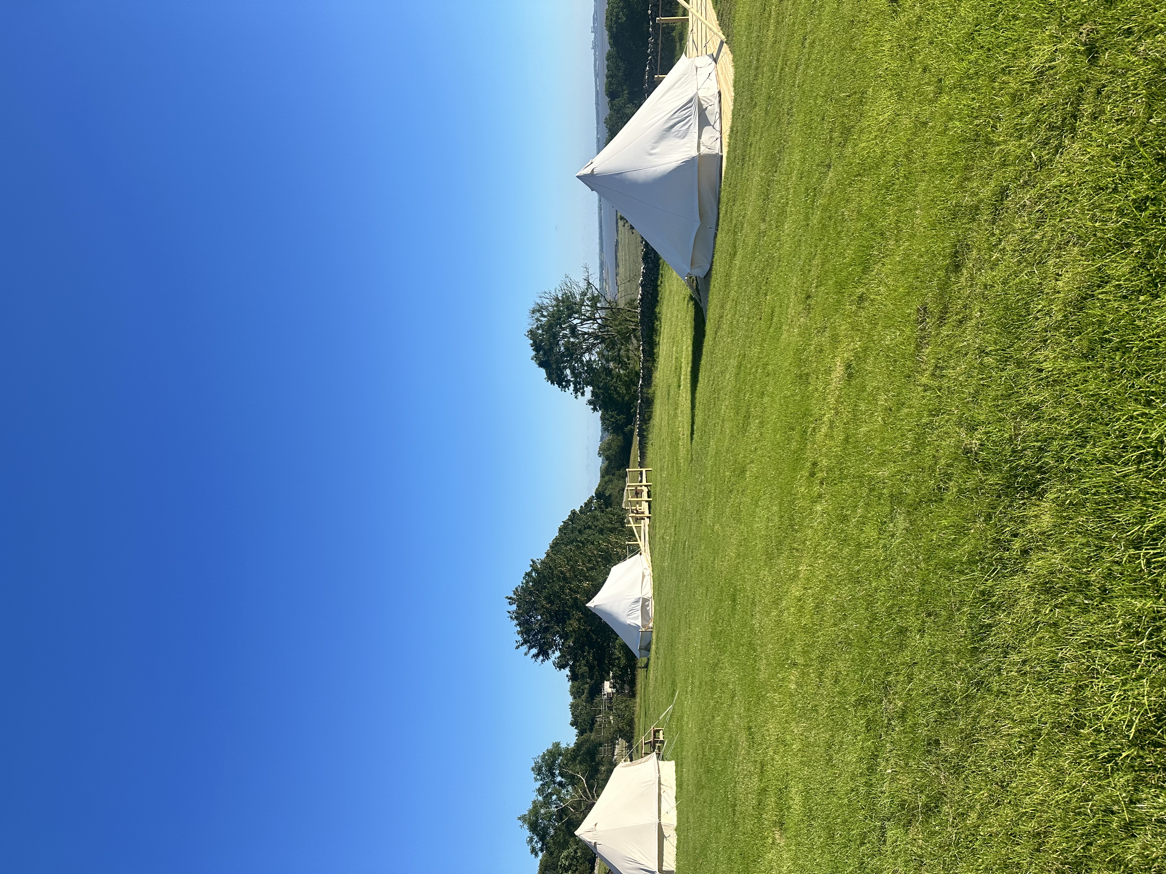 Side perspective of Glamping tent with lights at nightfall